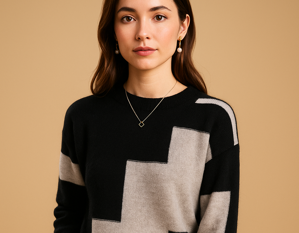 Astrid loose-fit sweater in black with grey colour-block panels, shown from the front