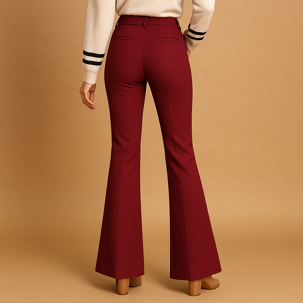 Delilah high-waist flared trousers in burgundy red seen from the back, worn with a cream top and heels