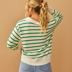 Back view of the cream and green striped knit sweater showing the closed back and ribbed hem