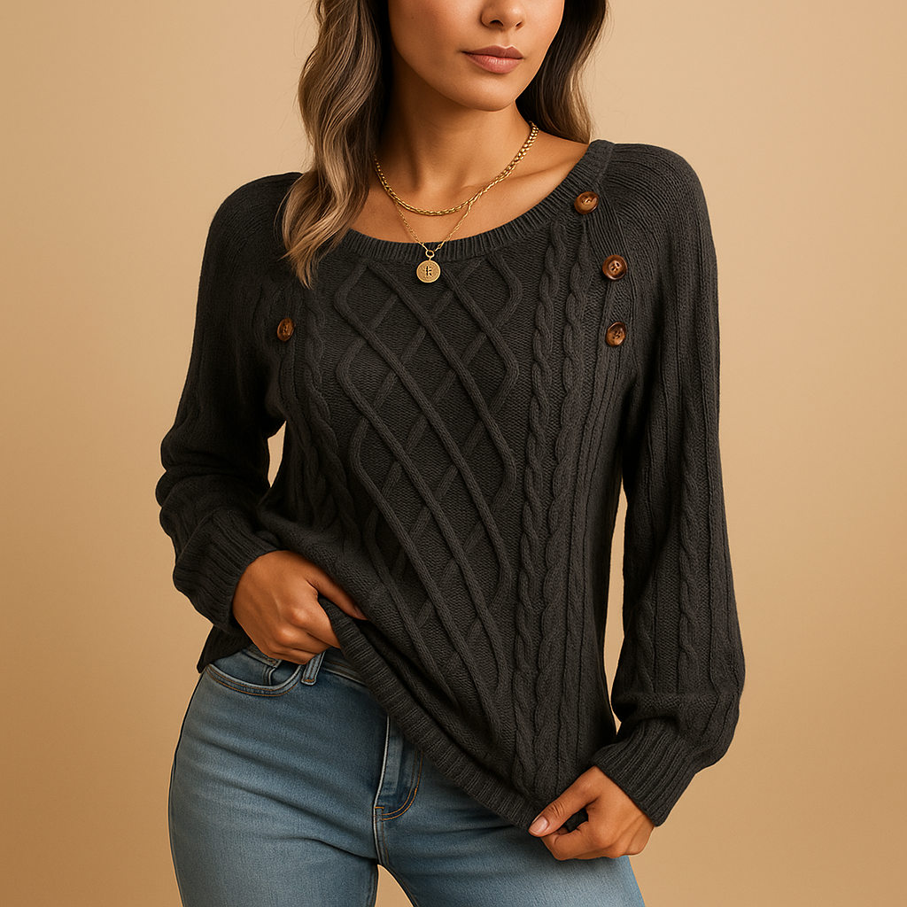 Marielle cable knit sweater in dark grey with shoulder buttons, worn with blue jeans