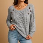 Marielle cable knit sweater in light grey with wooden buttons on the shoulder, worn with blue jeans