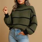 Scarlett striped knit sweater in olive green and black with a high collar, worn with blue jeans