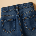 Flat lay close-up of the Sienna high-waisted loose fit jeans in mid blue denim showing the back pockets and belt loops