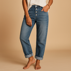 Sienna high-waisted loose fit jeans in mid blue denim with a button fly, worn with a white top